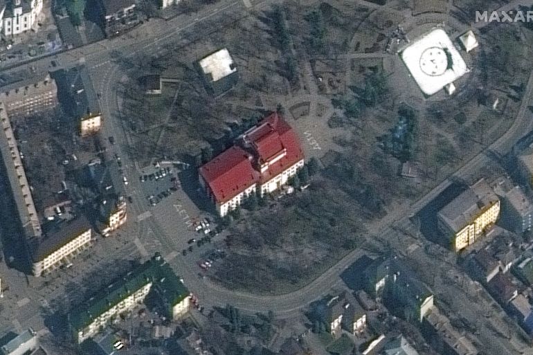 A satellite image shows a closer view of Mariupol Drama Theatre before bombing, as a word "children" in Russian is written in large white letters on the pavement in front of and behind the building, in Mariupol, Ukraine, March 14, 2022.