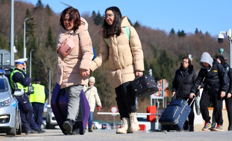 Refugees cross the border from Ukraine to Poland.