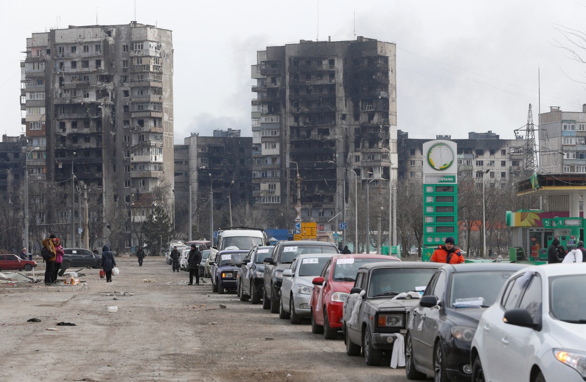 A view shows a line of cars near blocks of flats destroyed during Ukraine-Russia conflict, as evacuees leave the besieged port city of Mariupol