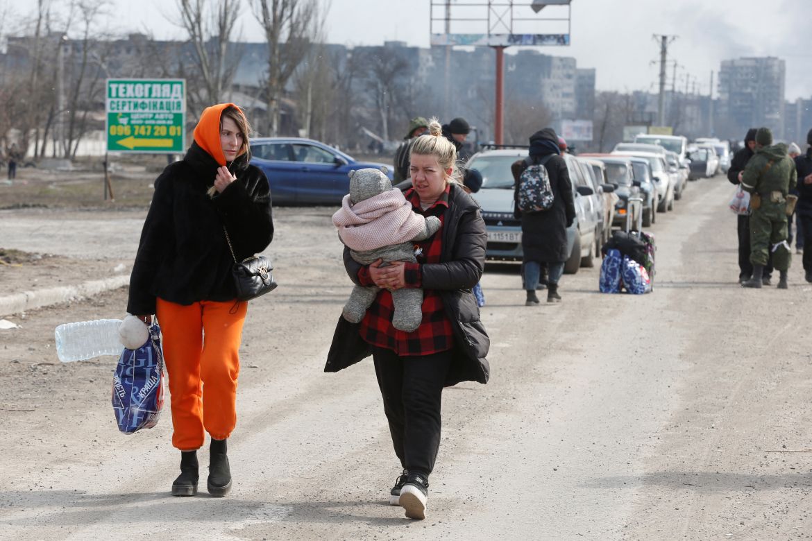 Evacuees fleeing Ukraine-Russia conflict walk out of the besieged southern port city of Mariupol,