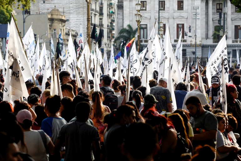 Demonstrators march in front of the National Congress as the Senate debates an agreement with the International Monetary Fund (IMF), in Buenos Aires, Argentina