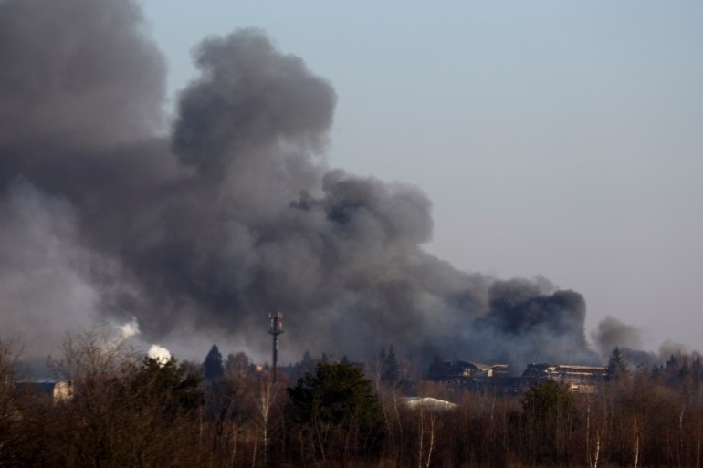 Smoke rises from a factory building near Lviv airport, as Russia's invasion of Ukraine continues, in Lviv, Ukraine