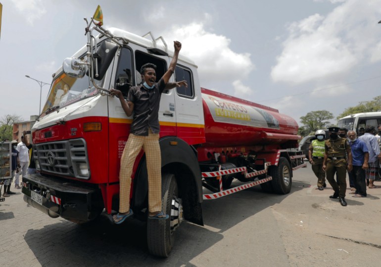 A man celebrates as the first oil bowser with kerosene arrives in Sri Lanka