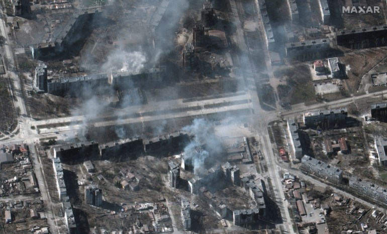 Smoke rises from buildings on fire in the besieged city of Mariupol in an image taken by satellite 