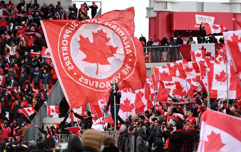Canada fans wave flags in the stands before kickoff against Jamaica