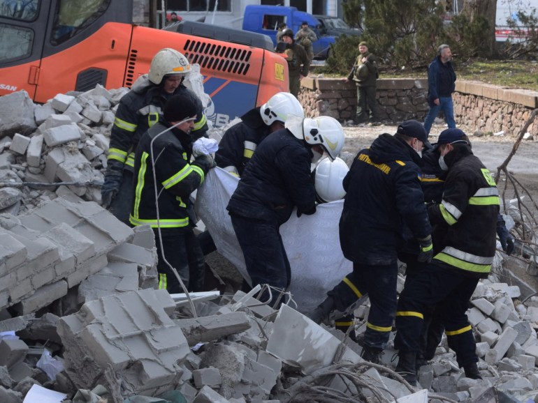 Rescuers evacuate a person from of the regional administration building hit by cruise missiles, as Russia's attack on Ukraine continues, in Mykolaiv, in this handout picture released March 29, 2022. Press service of the State 