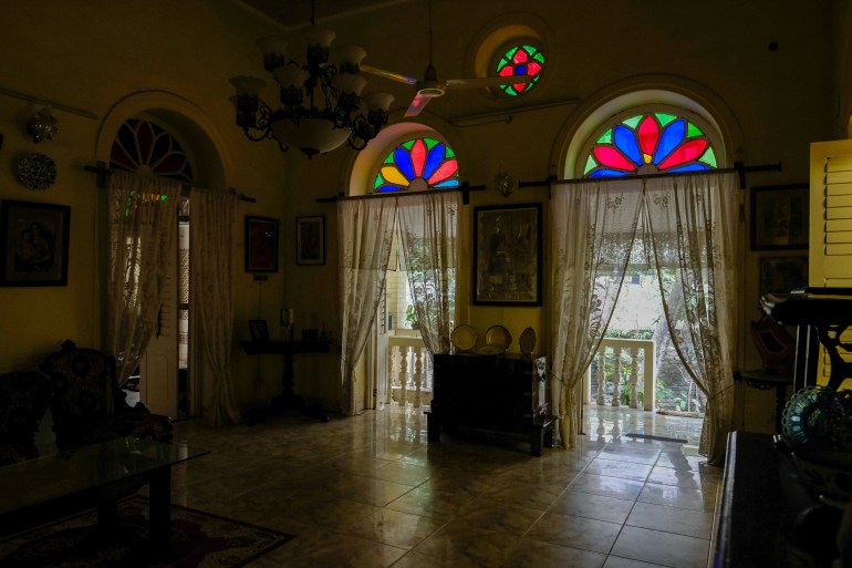 Two doors, crowned with stained glass transoms, lead out onto the terrace and garden