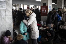 Kyiv residents flock to a train station to flee the city.