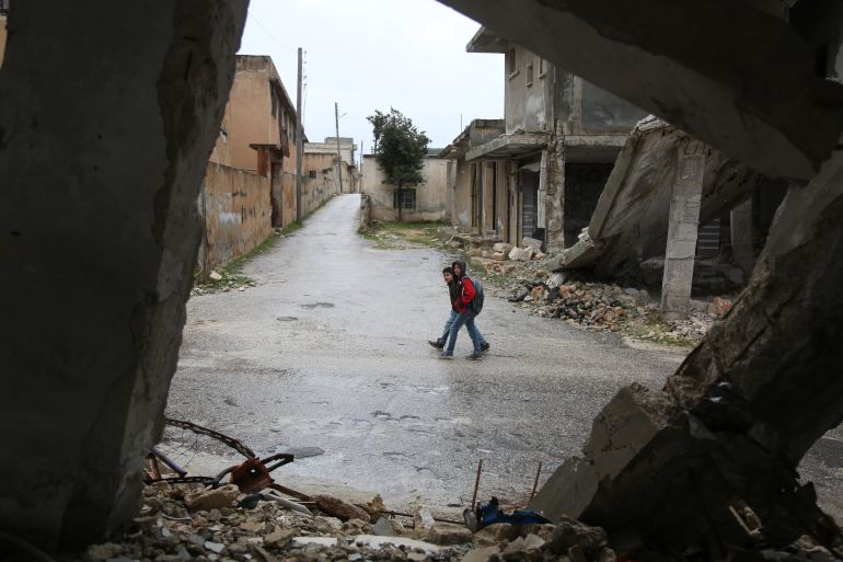 Children in the Syrian village of Baluon return to school after government forces shelling