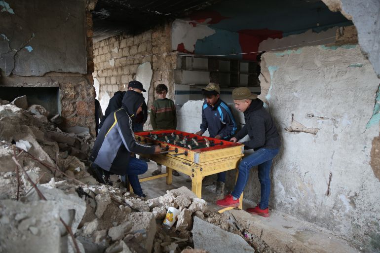 Children play table football in a building in southern Idlib province that was destroyed by airstrikes.