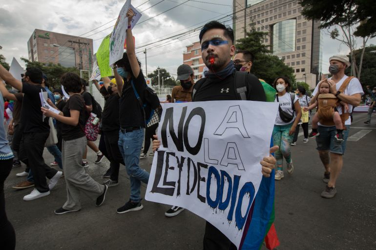 A protester holds a sign that reads "No to the hate law" during a march in Guatemala