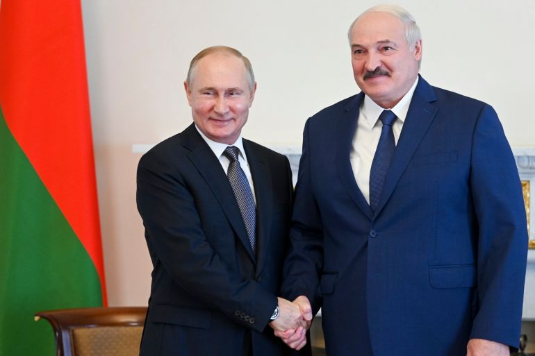 A photo of Russian President Vladimir Putin and Belarusian President Alexander Lukashenko shaking hands.