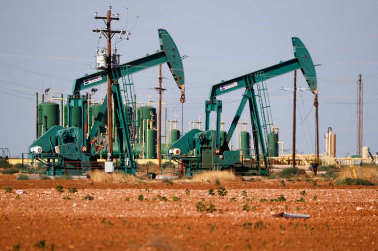 a view of a pump jack operateing in an oil field in Midland, Texas.