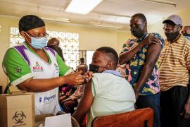Ugandans receive Pfizer coronavirus vaccinations at the Kiswa Health Centre III in the Bugolobi neighborhood of Kampala, Uganda Tuesday, Feb. 8, 2022