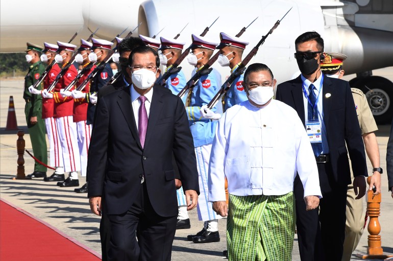 Hun Sen (left) reviews an honour guard with the Myanmar military's foreign minister on his arrival in Naypyidaw in January