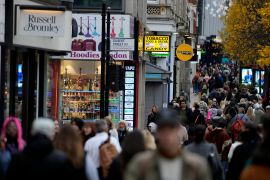 Shoppers walk along Oxford Street
