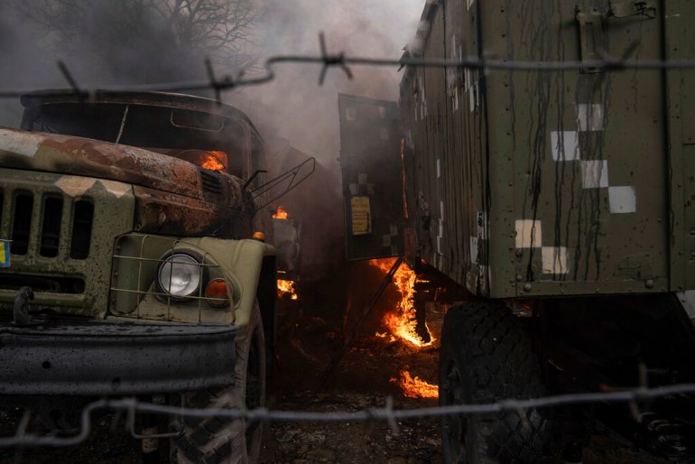 Military vehicles burning after a Russian attack in the outskirts of Mariupol.