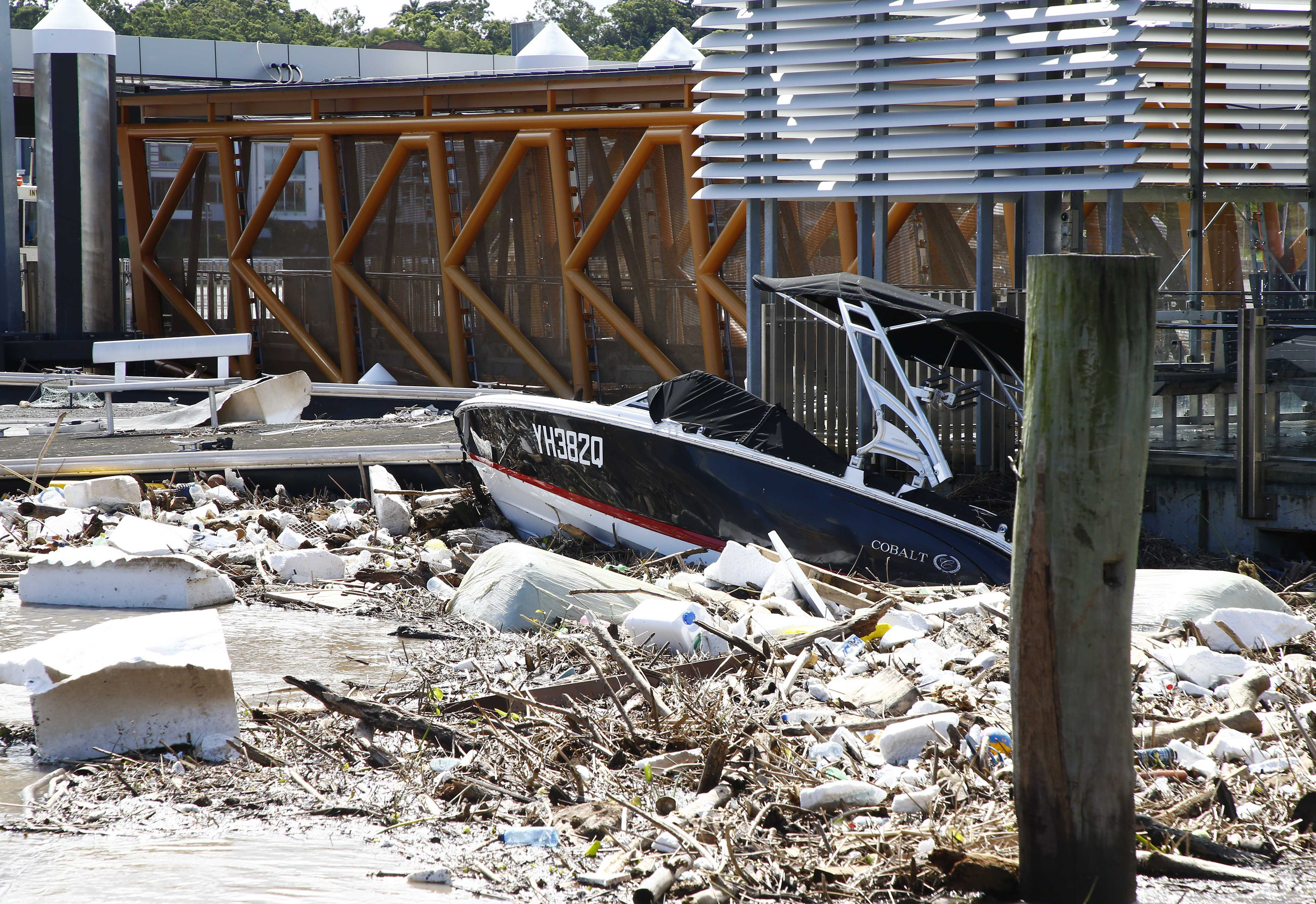 Wreckage are seen at the Hawthorne ferry terminal on the Brisbane river