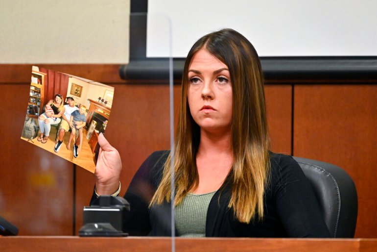 Chelsey Napper, the next door neighbor of Breonna Taylor, holds up an exhibit during questioning from the prosecution.