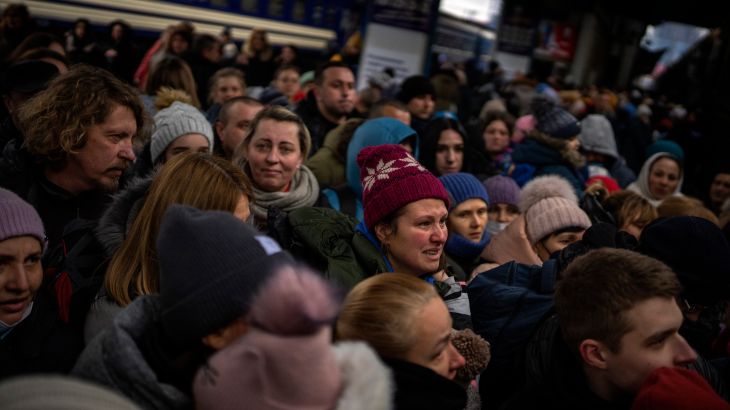 Women and children try to get onto a train bound for Lviv, at the Kyiv station in Ukraine