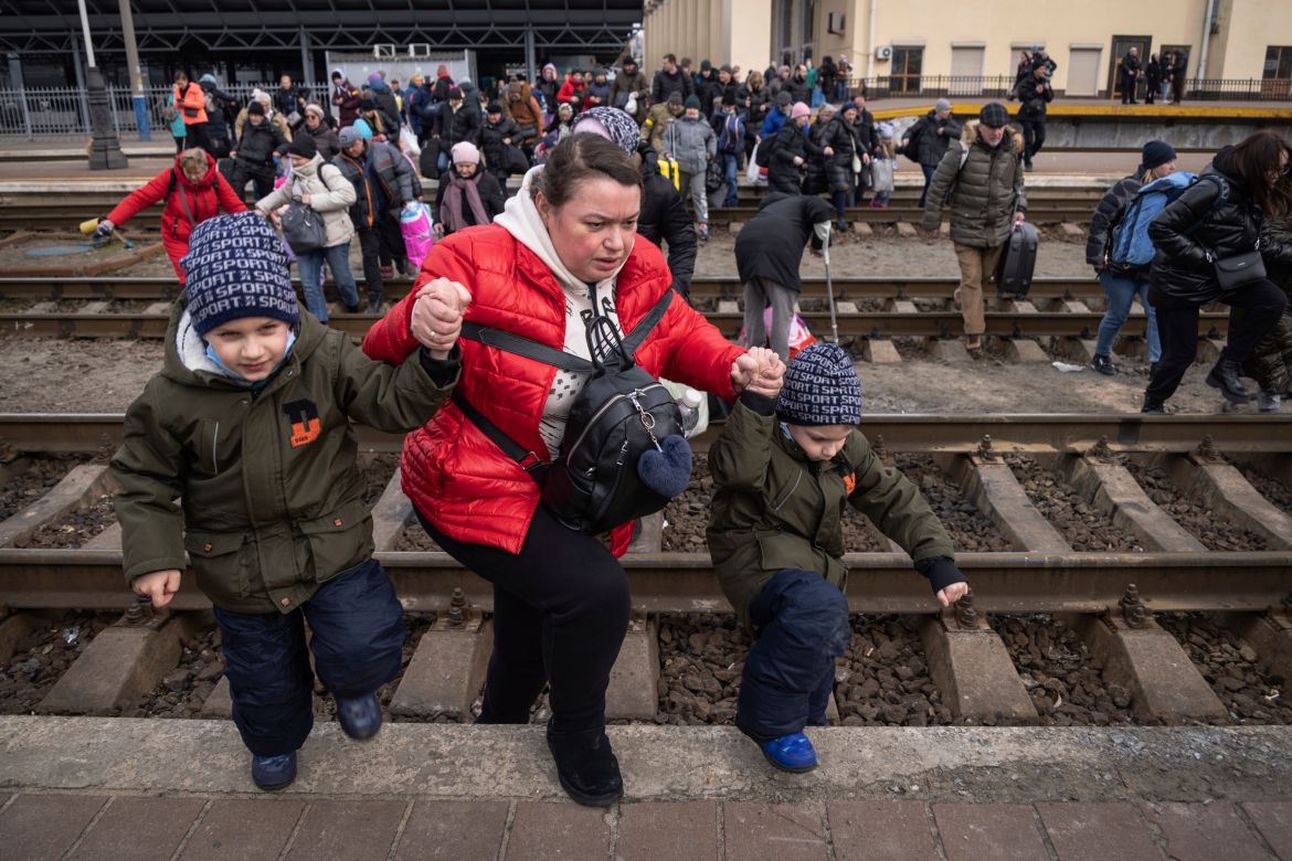 People, mostly women and children, try to get onto a train bound for Lviv, at the Kyiv railway station