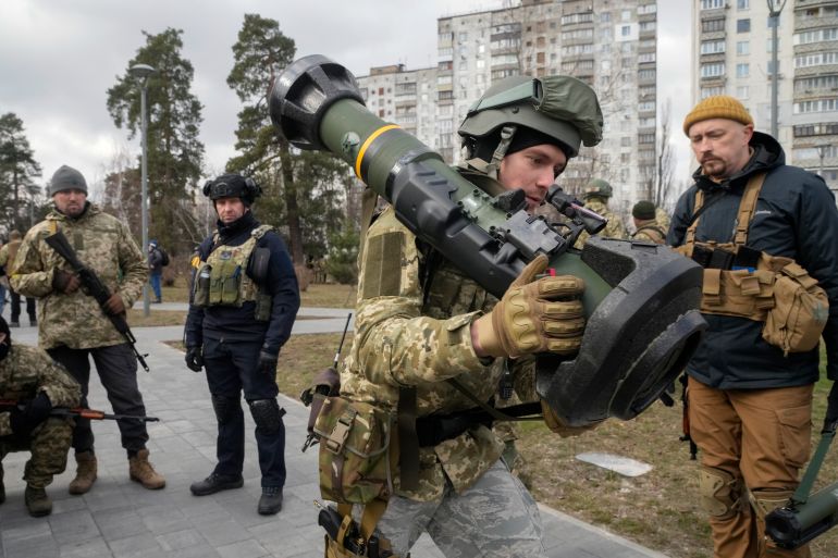 A Ukrainian Territorial Defence Forces member holds an NLAW anti-tank weapon, on the outskirts of Kyiv, Ukraine