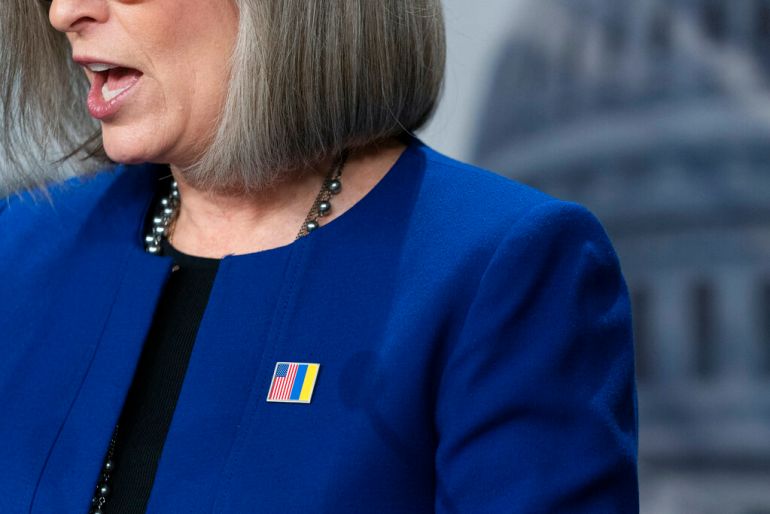 Republican Senator Joni Ernst wears a pin pairing the American red white and blue flag with the Ukrainian blue and yellow to showoff the embattled Eastern European nation.