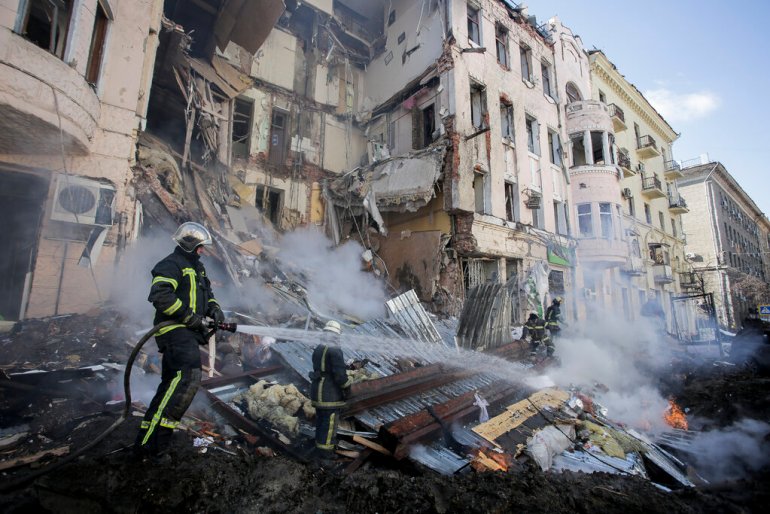 Firefighters extinguish an apartment house after a Russian rocket attack in Kharkiv.