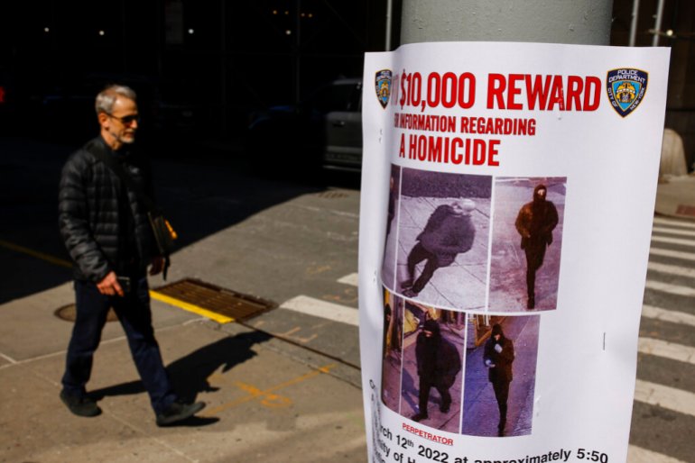  pedestrian walks past a bulletin posted by NYPD near the place where a homeless person was killed days earlier in lower Manhattan.