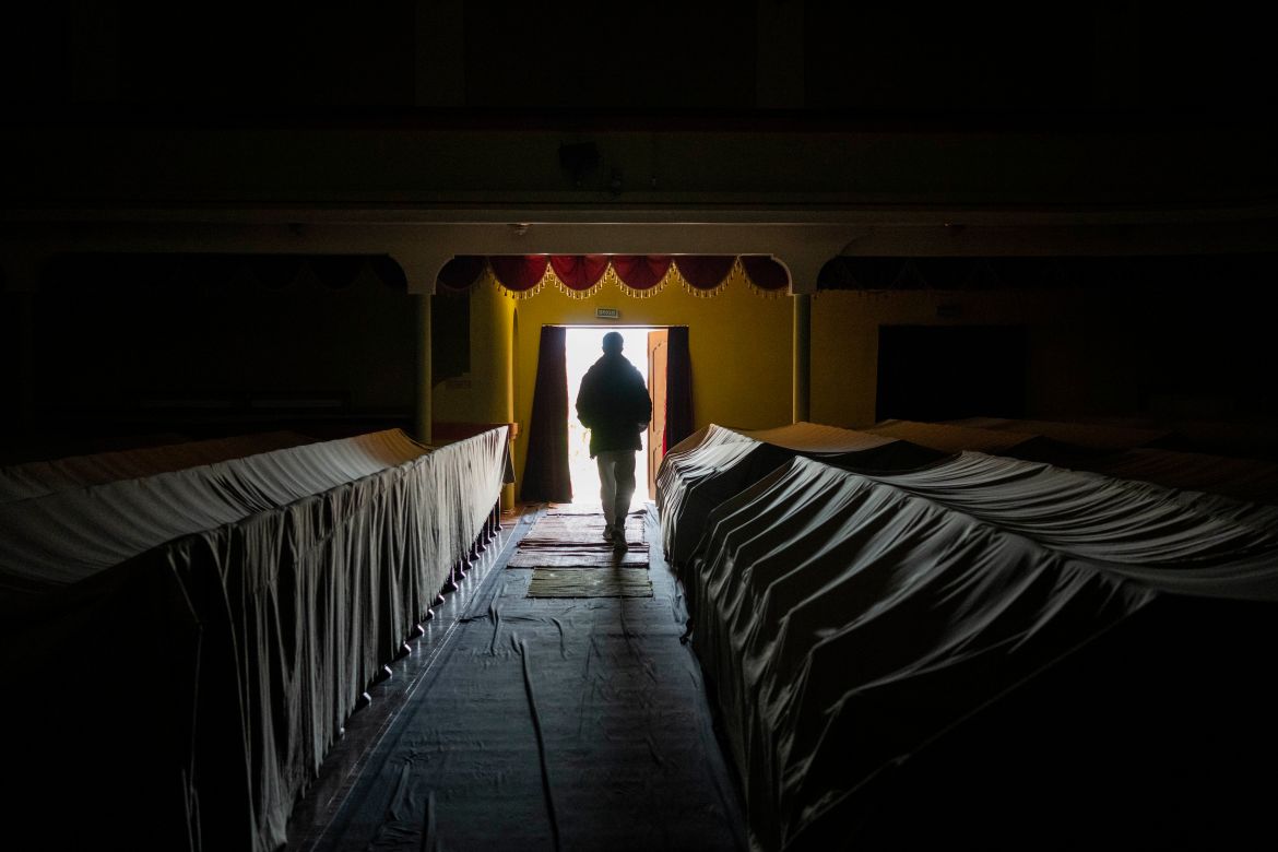 A volunteer walks trhough the audience rows of a theatre in the city of Drohobych