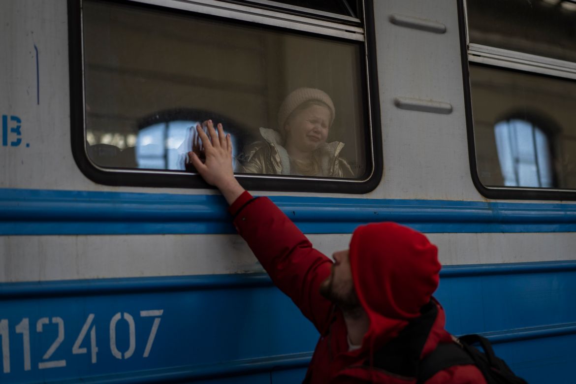 Displaced Ukrainians on a Poland-bound train bid farewell in Lviv