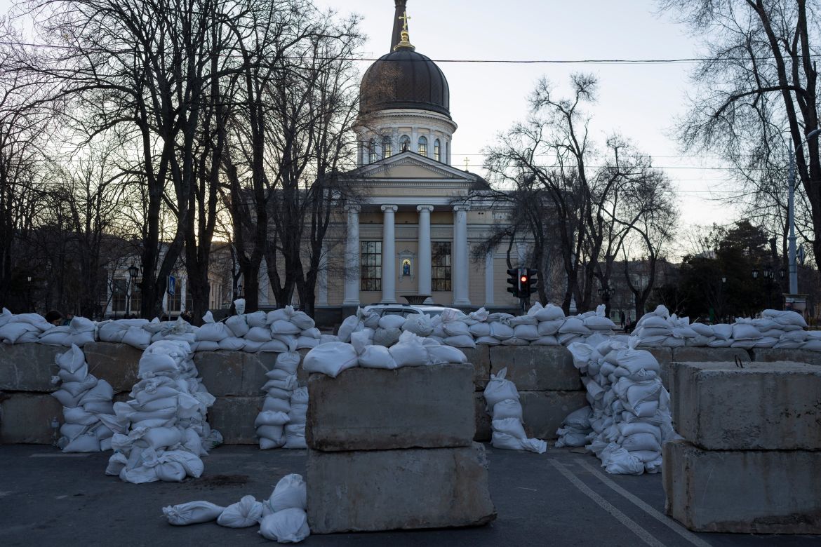 Concrete blocks topped with sandbags block a street in Odesa