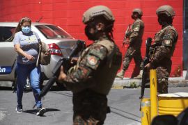 soldiers man a checkpoint in El Salvador