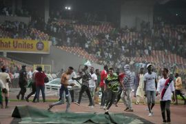 Police fire tear gas to try to remove spectators from the pitch at the end of the Ghana and Nigeria 2022 Qatar World Cup qualifying playoff