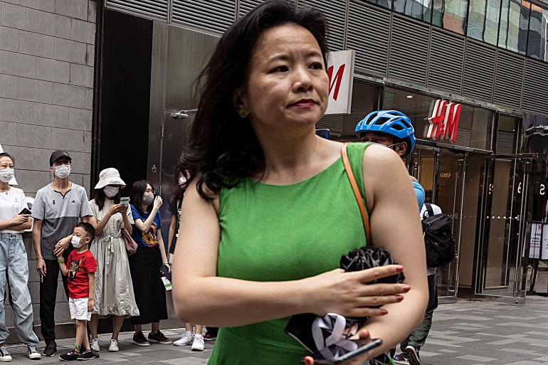 Cheng Lei, in a green sleeveless top, out and about in Beijing in 2020