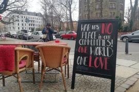 A sandwich board outside a Berlin Russian Jewish restaurant has a message of peace