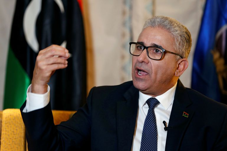 Fathi Bashagha speaks with a Libyan flag on the background.