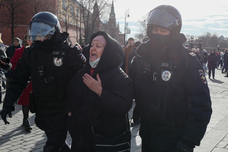 Russian policemen arrest a participant in an unauthorized rally against the Russian invasion of Ukraine, in downtown Moscow