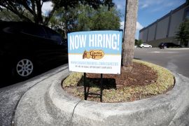 A Cracker Barrel restaurant displays a "Now Hiring" sign in Tampa, Florida, US