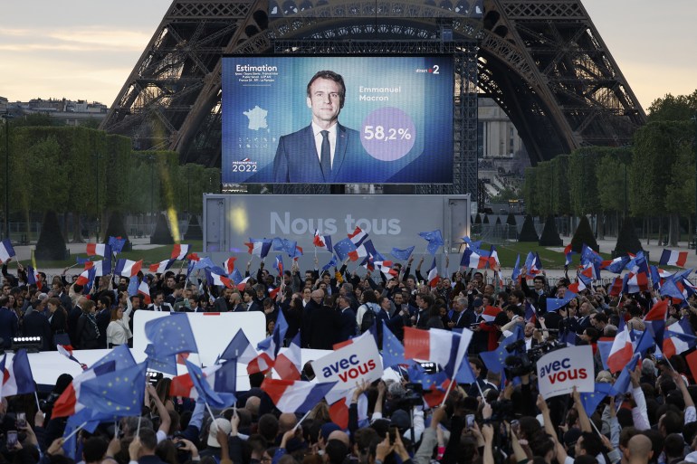 Supporters react after the victory of French President and La Republique en Marche (LREM) party candidate for re-election Emmanuel Macron