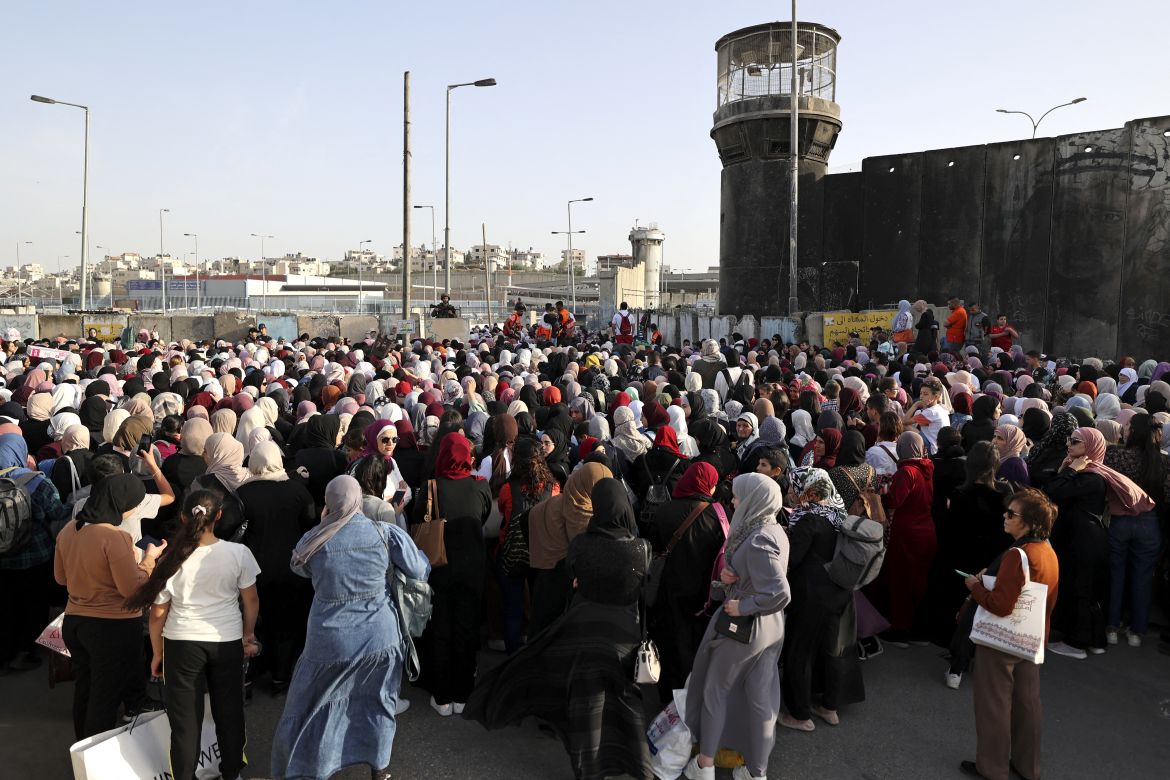 Palestinians arrive in large numbers to the Israeli-controlled Qalandia checkpoint in the occupied West Bank