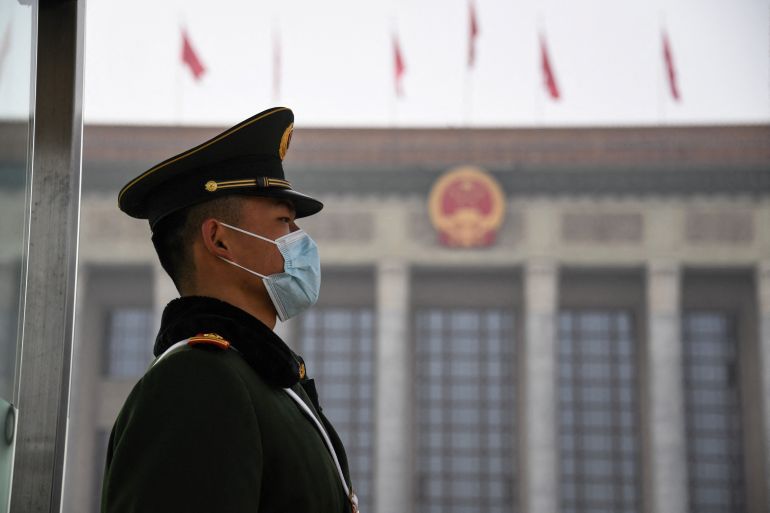 A Chinese paramilitary police officers stands guard outside the Great Hall of the People in Beijing