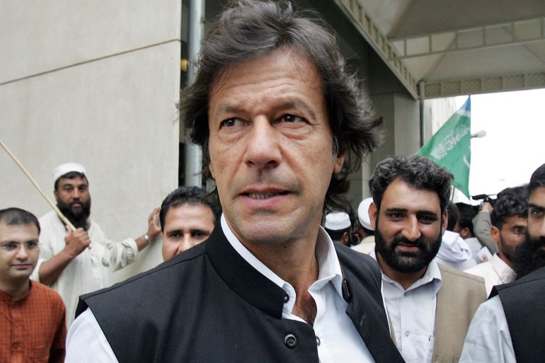Pakistani cricketer-turned-politician Imran Khan (C) leaves the Supreme Court in Islamabad