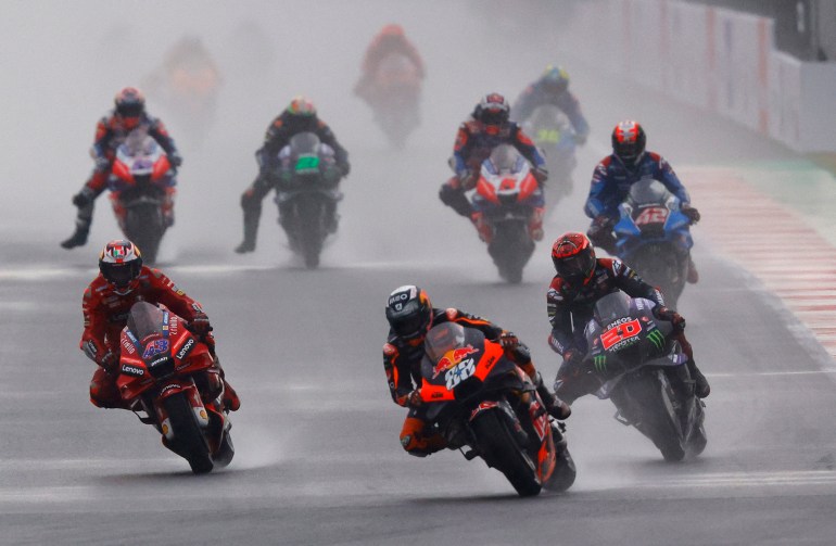 Motorcyclists race through torrential rain and spray at Lombok's Mandalika Circuit