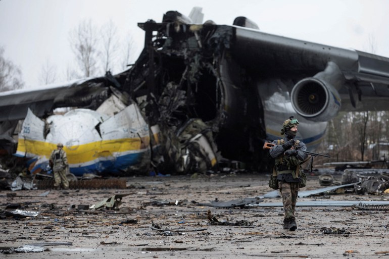 A Ukrainian service member is seen at the Hostomel airfield