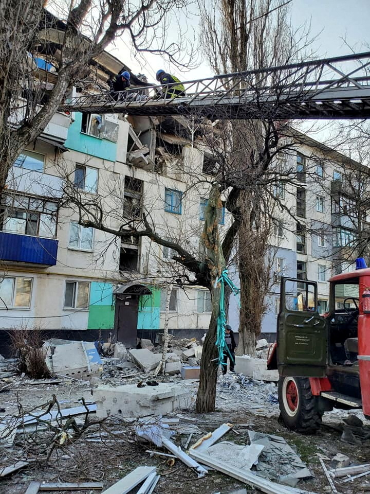 Rescuers evacuate a person from a residential building damaged by a military strike, as Russia's attack on Ukraine continues, in Lysychansk, Luhansk region, Ukraine