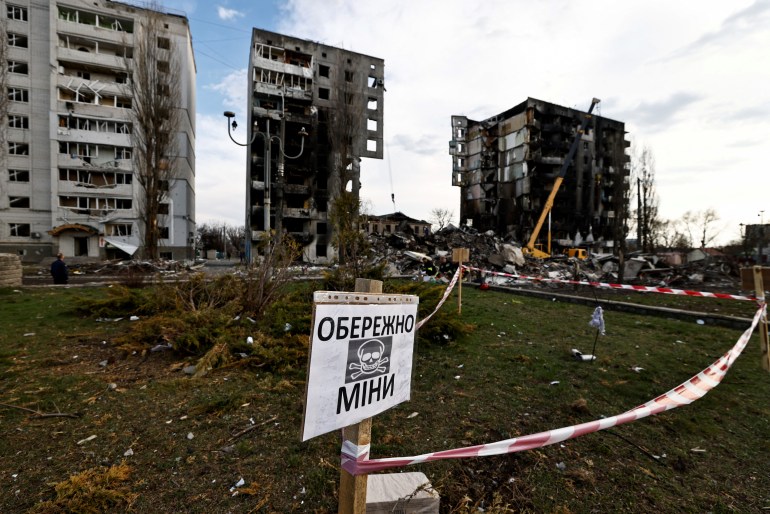 A mine warning sign is seen in front of buildings that were destroyed by Russian shelling, amid Russia's invasion of Ukraine, in Borodyanka, Kyiv region,