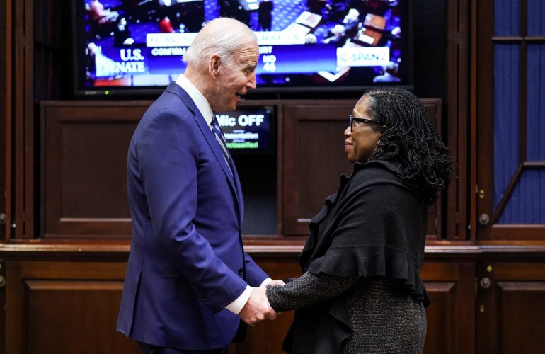 Joe Biden holds hands with Ketanji Brown Jackson after her Supreme Court nomination was confirmed
