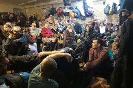 Residents of Yahidne are seen in the basement of a school in March