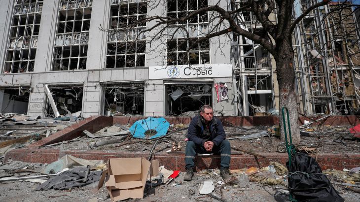 A resident looks on near a building destroyed in the course of the Ukraine-Russia conflict, in the southern port city of Mariupol, Ukraine April 10, 2022. REUTERS/Alexander Ermochenko TPX IMAGES OF THE DAY